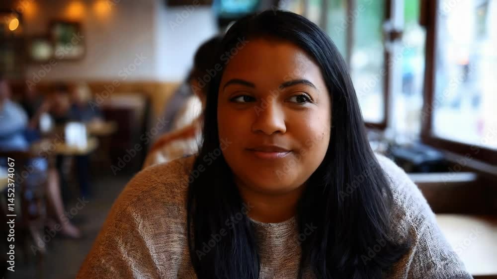 In a cozy café, a Hispanic woman in a sweater shares smiles with friends and patrons during engaging conversations In a cozy café, a Hispanic woman in a sweater shares smiles with friends and patrons during engaging conversations