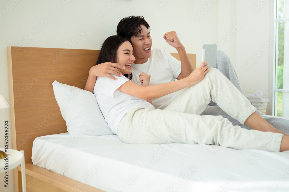 Couple Enjoying Time Together in Bed With a Tablet During the Morning Couple Enjoying Time Together in Bed With a Tablet During the Morning