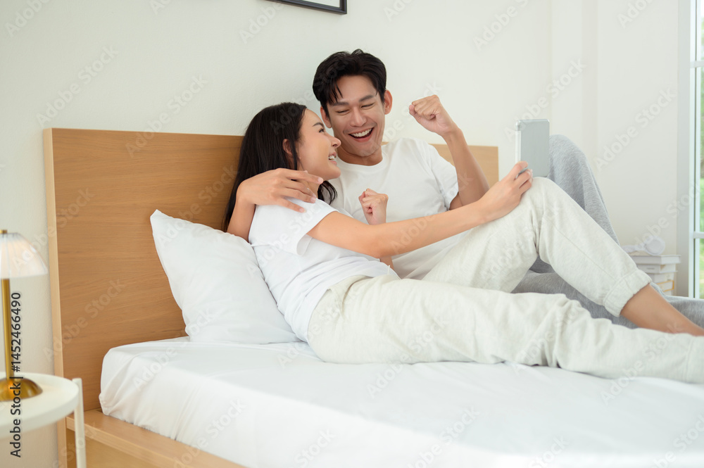 Couple Enjoying Time Together in Bed With a Tablet During the Morning Couple Enjoying Time Together in Bed With a Tablet During the Morning