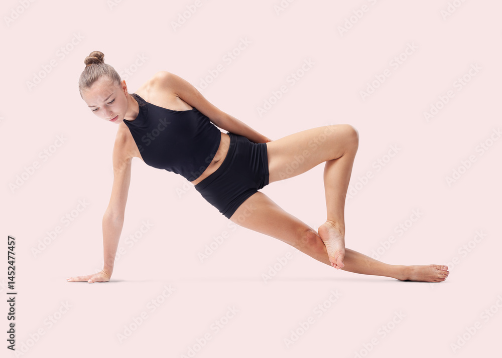 Young woman doing artistic gymnastics training, flexible rhythmic gymnast performing poses and showing skills and talent, sport workout, fitness and Well-Being concept, isolated on pink background Young woman doing artistic gymnastics training, flexible rhythmic gymnast performing poses and showing skills and talent, sport workout, fitness and Well-Being concept, isolated on pink background