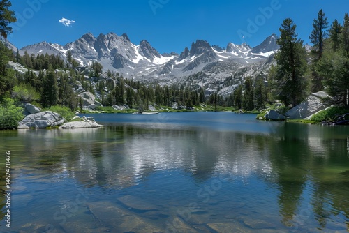Serene Mountain Lake Reflecting Majestic Peaks Under a Clear Blue Sky: A Breathtaking Vista of Nature's Beauty in Tranquil Surroundings, Showcasing the Untouched Wilderness and Picturesque Scenery.
