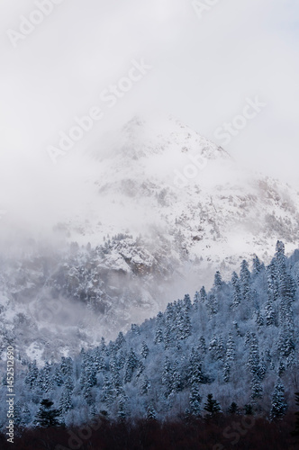 Snowy mountain range under white sky