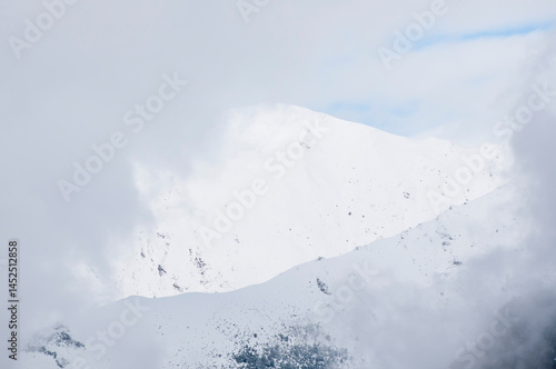 Dramatic snow cornice on high mountain slope