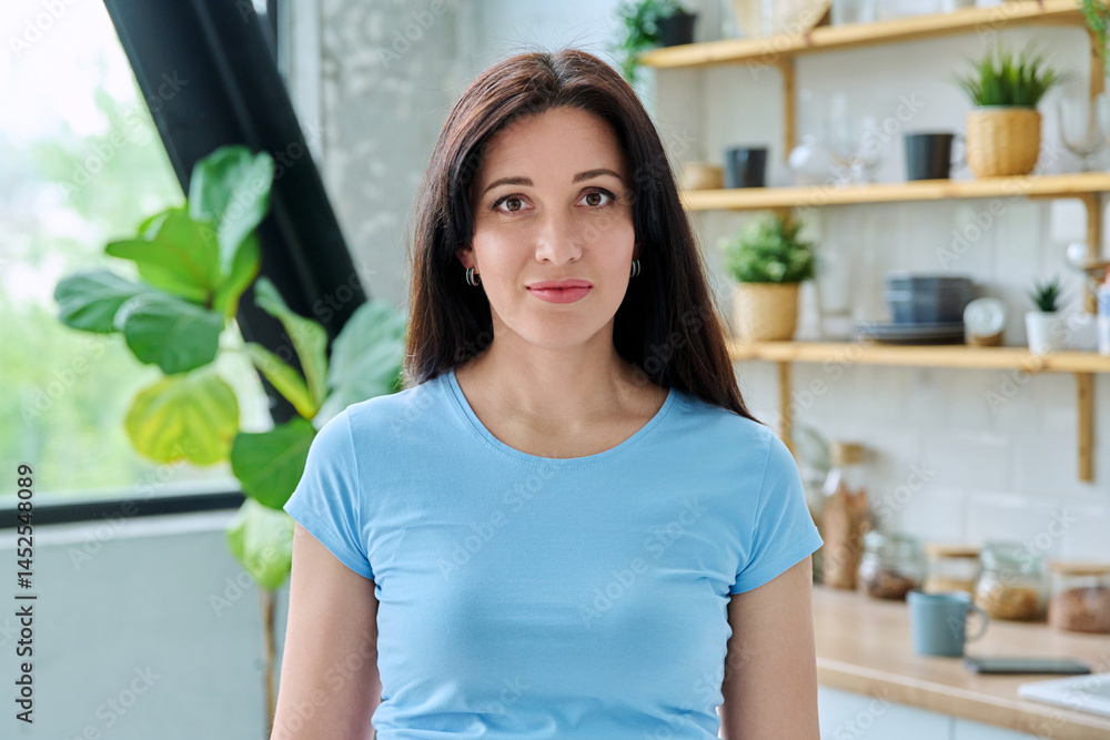 Headshot portrait young smiling woman at home in kitchen