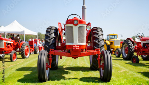Vintage red tractor on display in sunny outdoor setting  
