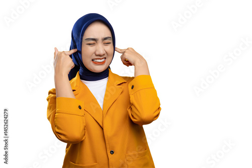 Tablou pe pânză Annoyed young Asian woman plugging her ears with finger and showing displeased e