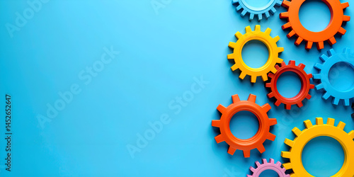 Gears engineering mechanics industrial concept. Colorful gears arranged on a blue background, symbolizing mechanical processes.