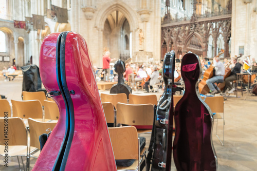 Obraz na płótnie Shallow focus of large hello string instrument cases seen in a famous English cathedral during a live performance. The orchestra can be seen in the background. w salonie