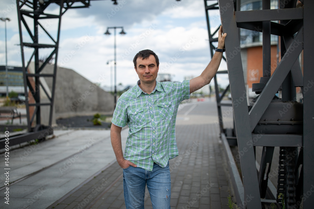 Portrait of handsome man outdoors in industrial area
