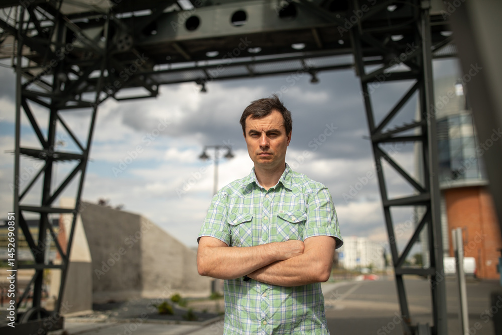 Portrait of handsome man outdoors in industrial area