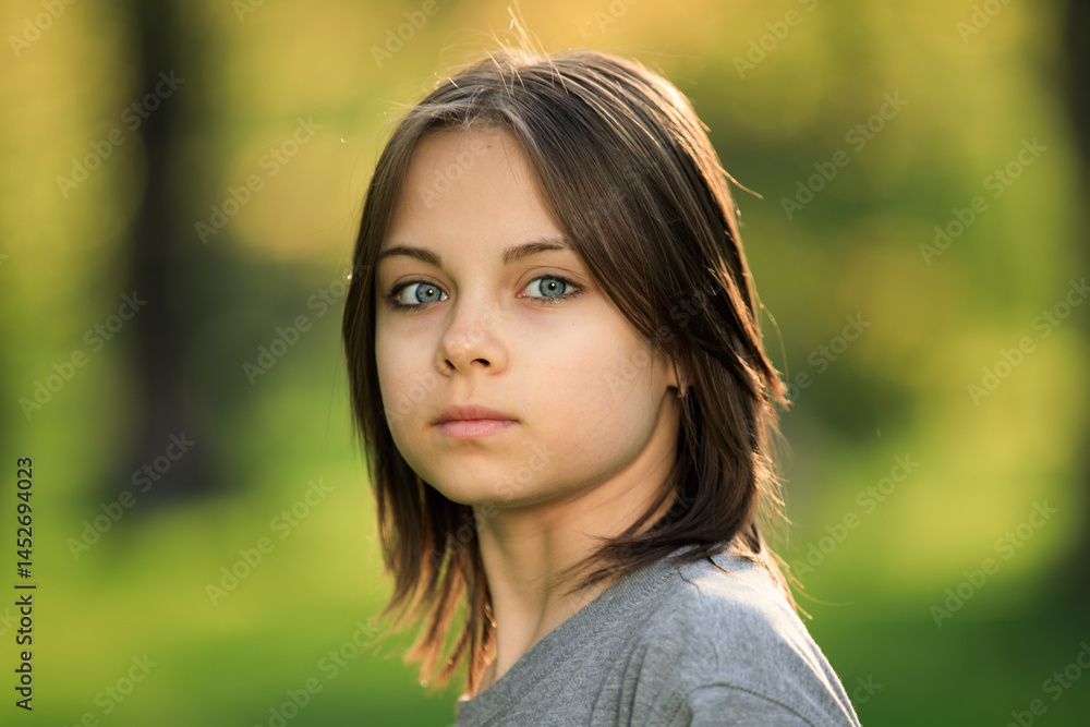 Portrait of preteen girl in park in spring