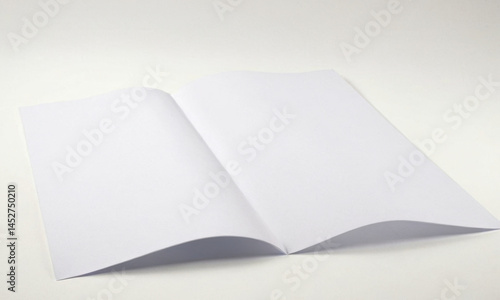 Obraz na płótnie An open white book lying on a white surface w salonie