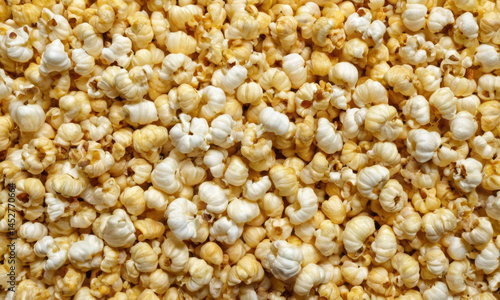 Obraz na płótnie A bowl of freshly popped popcorn sits on a table, ready to be enjoyed w salonie