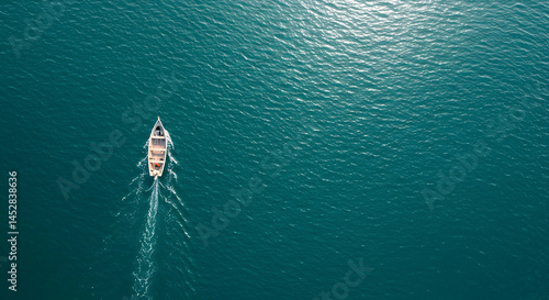 Aerial View of a Single Boat Sailing Over Calm Blue Waters