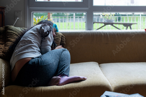 Obraz na płótnie Depressed woman sitting on sofa at home, feeling sad and lonely w salonie