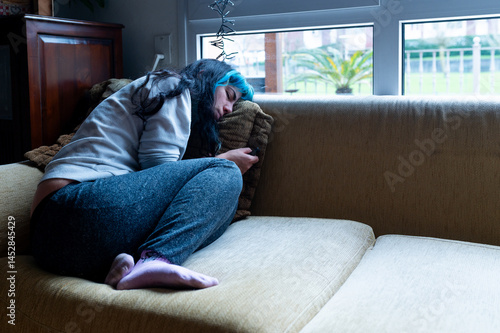 Obraz na płótnie Sad woman suffering from depression, lying on the sofa at home w salonie