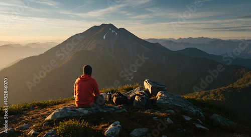 Serene Hiker Overlooking Majestic Mountain Landscape at Sunrise