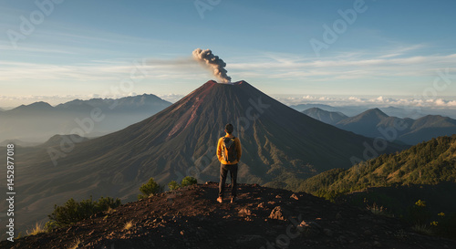 Breathtaking View of Erupting Volcano at Sunrise with Hiker