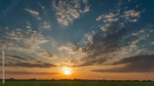 A large field with a level lawn stretching out over the horizon at sunset.