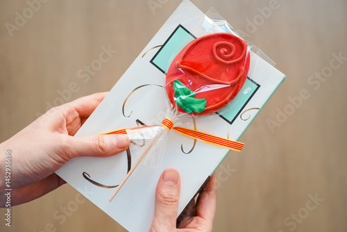 Photography Día de Sant Jordi, Mujer regalando galleta con forma de rosa y un libro