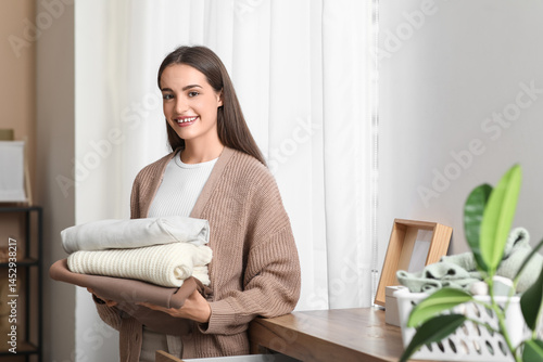 Young woman with stack of c...