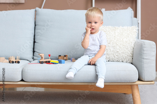 Crying baby boy with toys o...