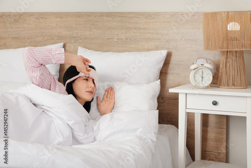 Sleepy young woman with mas...