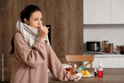 Ill young woman coughing in...