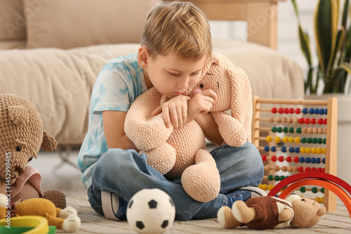 Cute little boy hugging toy...