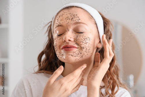 Young woman applying natura...