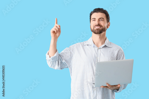 Handsome man with laptop po...