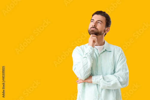 Thoughtful young man lookin...