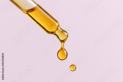Organic Skincare Oil Dropper and Serum with Glass Pipette on Pink Background