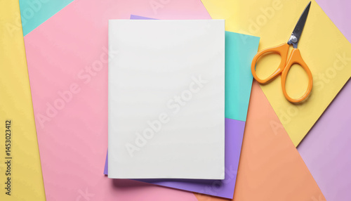 Booklet mockup with scissors on colorful craft paper background
