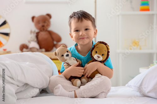 Cute little boy with toys s...