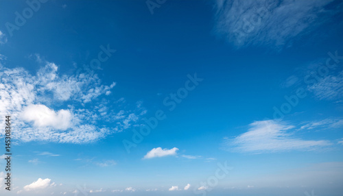a serene scene of clear blue skies with wispy white clouds peacefully drifting in the airy atmosphere creating a tranquil copy space image