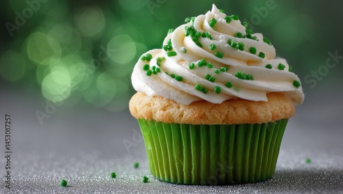 St. Patrick’s Day cupcake with green sprinkles on gray surface, holiday dessert