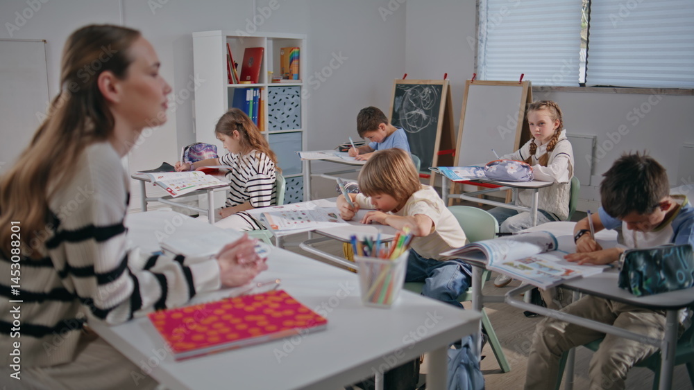 Female teacher explaining lesson in classroom closeup. Schoolteacher talking