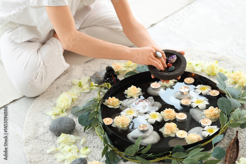 Woman with stones, flowers ...