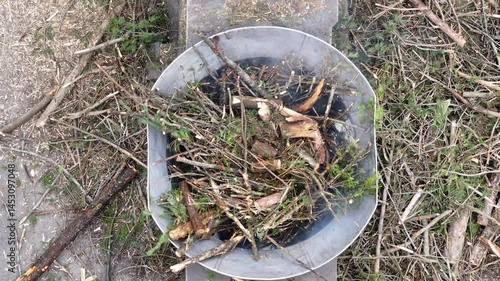 Wallpaper Mural Aerial drone shot looking straight down at a giant tub grinder devouring storm-felled tree debris, tossing shredded wood into spinning heaps below, showcasing powerful post-storm grinding action. Torontodigital.ca