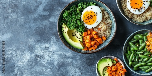 Variety of bowls filled with healthy foods. Includes eggs, veggies, grains and possibly some meat.