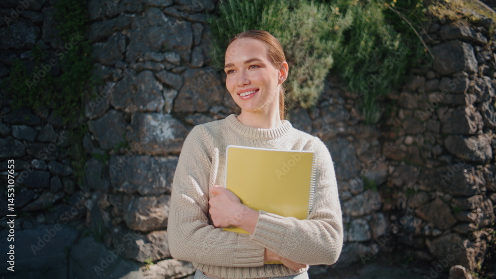 Carefree teacher woman posing city park portrait. Student girl holding book