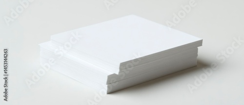 Stack of white paper sits neatly, representing potential for business or creative projects.