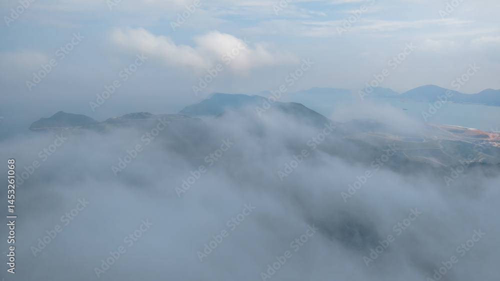 Fototapeta premium View of Hills Covered in Mist Overlooking the Coastal Landscape