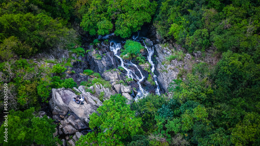 View of a Serene Waterfall Cascading Through Lush Green Forest View of a Serene Waterfall Cascading Through Lush Green Forest