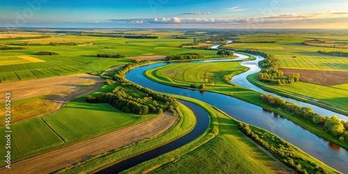 Aerial view of a meandering river surrounded by lush green farm fields on a sunny day in rural North Dakota, agriculture, farm fields