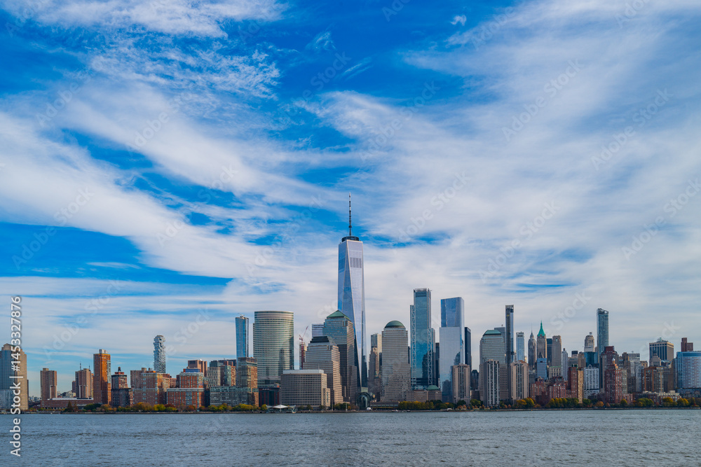 Obraz premium New York City cloudy skyline. NYC skyscrapers. Manhattan. NY cityscape with clouds. Downtown New York buildings. NYC skyline on clouds. New York harbor view. Skyscrapers in Manhattan. NYC downtown.