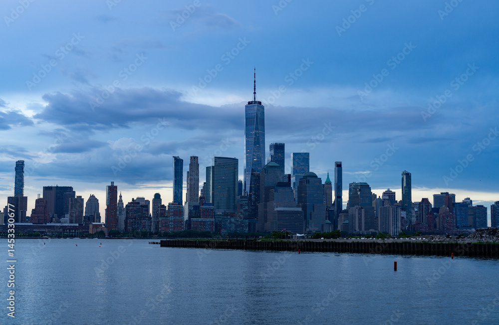 Fototapeta premium NYC, New York City Skyline with dramatic sky clouds. New York Skyscrapers. New York City skyline, cityscape of Manhattan in USA. Panoramic view on Manhattan. New York skyline. NYC, NY city.