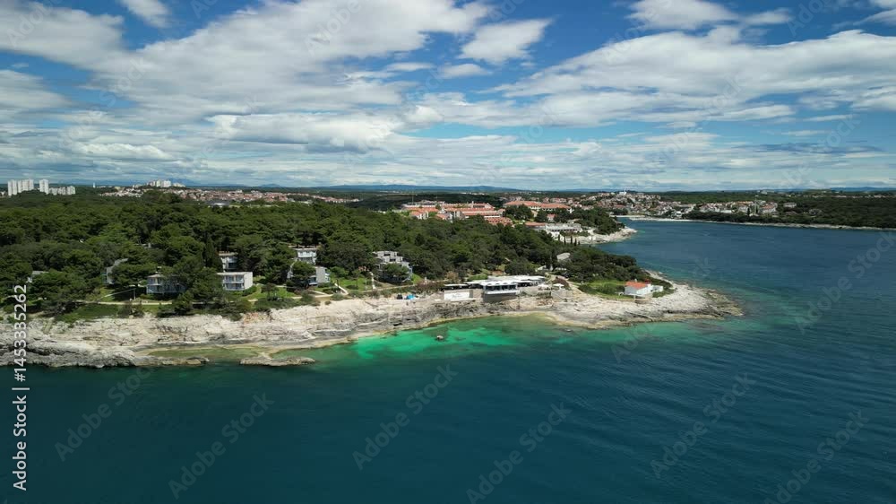 Aerial view of seafront buildings merged with dense green vegetation on the shore of Pula, Croatia Aerial view of seafront buildings merged with dense green vegetation on the shore of Pula, Croatia