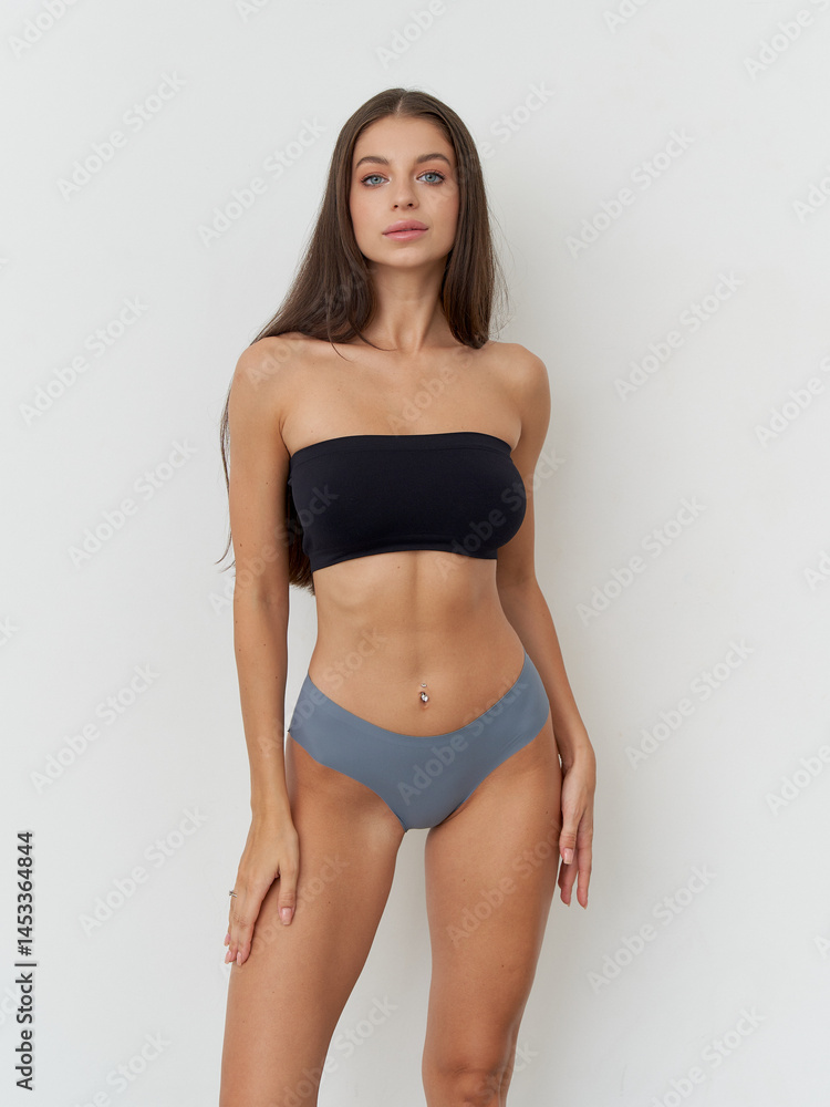 Elegance in simplicity with a modern model showcasing fashion in a studio setting Elegance in simplicity with a modern model showcasing fashion in a studio setting